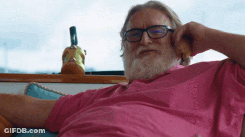 A Man Wearing Glasses And A Pink Shirt Is Talking On A Phone GIF