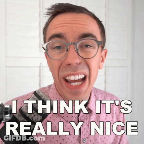 A Man Wearing Glasses And A Pink Shirt Says " I Think It 'S Really Nice " In Front Of A Microphone GIF