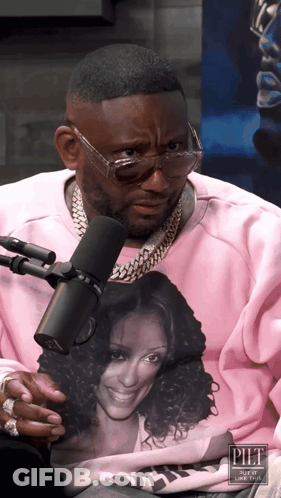 A Man Wearing Glasses And A Pink Sweatshirt With A Picture Of A Woman On It GIF