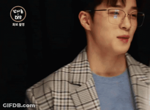 A Man Wearing Glasses And A Plaid Jacket With The Bnt Logo In The Corner GIF