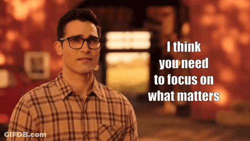 A Man Wearing Glasses And A Plaid Shirt Says " I Think You Need To Focus On What Matters " In Front Of A Building GIF