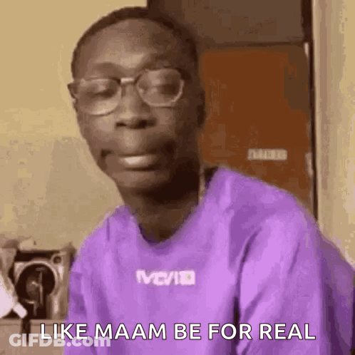 A Man Wearing Glasses And A Purple Shirt Is Making A Face . GIF
