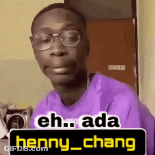 A Man Wearing Glasses And A Purple Shirt Is Making A Funny Face And Saying Eh Ada Henny Chang . GIF