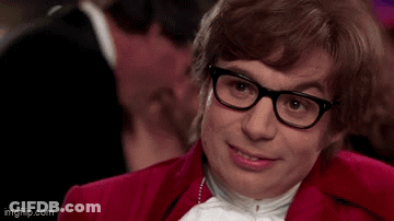A Man Wearing Glasses And A Red Jacket Is Asking Come Again ? GIF