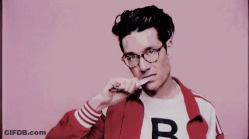 A Man Wearing Glasses And A Red Jacket Is Brushing His Teeth With A Toothbrush . GIF