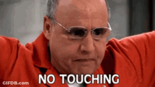 A Man Wearing Glasses And A Red Jacket Is Holding His Arms Out And Says `` No Touching '' . GIF