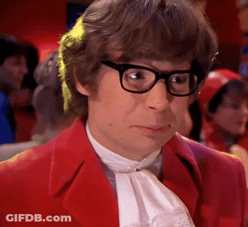 A Man Wearing Glasses And A Red Jacket Looks Serious GIF