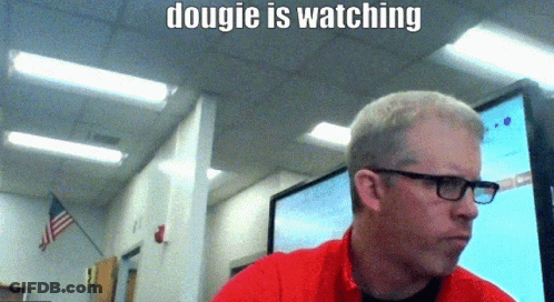 A Man Wearing Glasses And A Red Shirt Is Sitting In Front Of A Computer Monitor With The Caption " Dougie Is Watching " GIF
