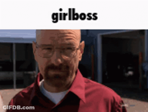 A Man Wearing Glasses And A Red Shirt Is Standing In Front Of A Garage With The Words Girlboss Written Above Him GIF