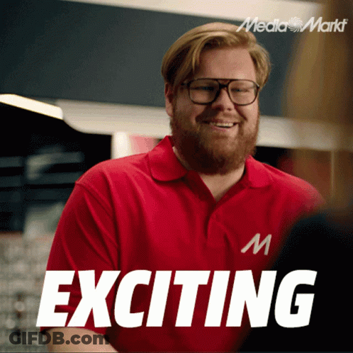 A Man Wearing Glasses And A Red Shirt With Exciting Written On It GIF
