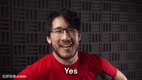 A Man Wearing Glasses And A Red Shirt With The Word Yesssss On It GIF