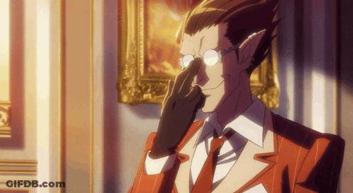 A Man Wearing Glasses And A Red Suit Has His Hand To His Nose GIF