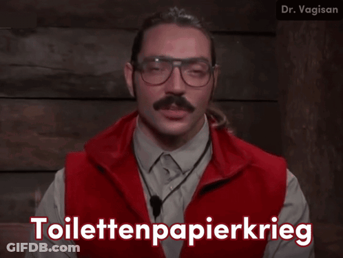 A Man Wearing Glasses And A Red Vest Says Toilettenpapierkrieg In White Letters GIF