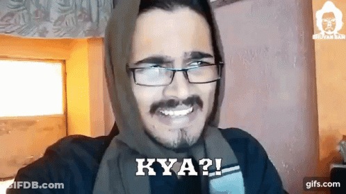 A Man Wearing Glasses And A Scarf On His Head Is Smiling And Says Kya ? GIF