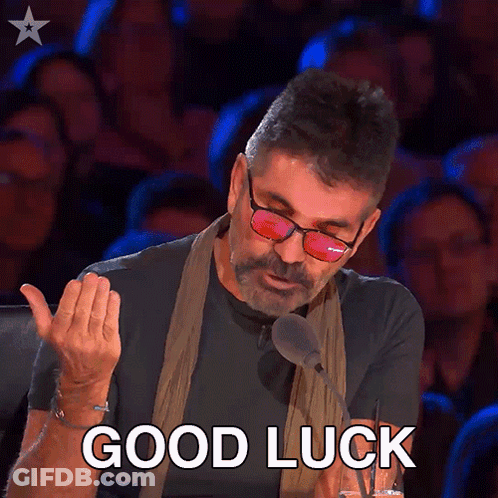 A Man Wearing Glasses And A Scarf Says " Good Luck " GIF