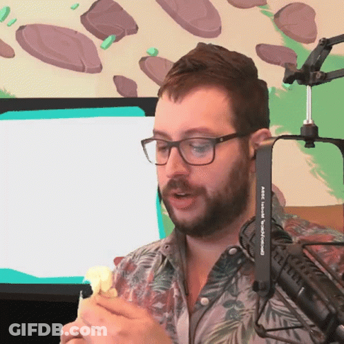 A Man Wearing Glasses And A Shirt That Says Abc On It Is Talking Into A Microphone GIF