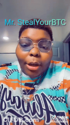 A Man Wearing Glasses And A Shirt That Says " Mr. Steal Your Btc " GIF