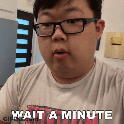 A Man Wearing Glasses And A Shirt That Says Wait A Minute On It GIF