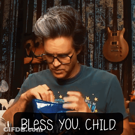 A Man Wearing Glasses And A Shirt That Says ' Will Be ' On It Is Holding A Bowl And Says Bless You Child GIF