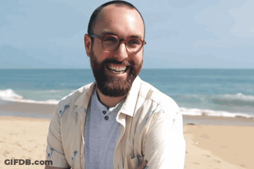 Man In Glasses Smiling On Beach With Palm Tree Shirt GIF