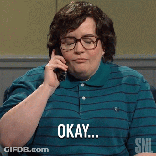A Man Wearing Glasses And A Striped Shirt Says Okay On The Phone GIF