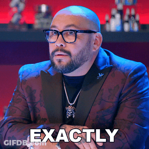 A Man Wearing Glasses And A Suit Has Exactly Written On The Bottom Of His Face GIF