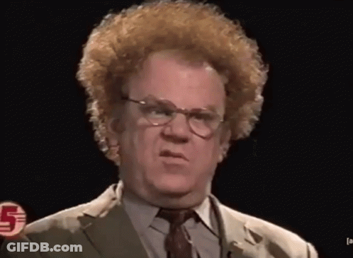 A Man Wearing Glasses And A Suit Has The Number 5 On His Chest GIF