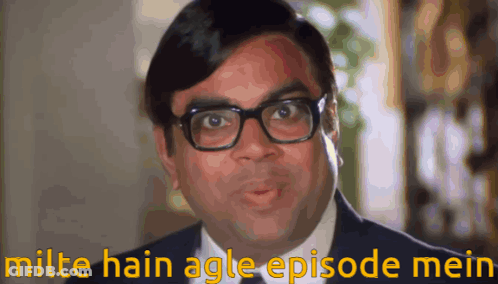 A Man Wearing Glasses And A Suit Has The Words Milte Hain Agle Episode Mein Above Him GIF