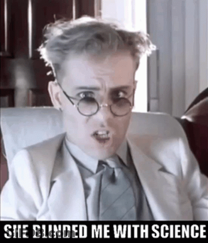 A Man Wearing Glasses And A Suit Has The Words She Blinded Me With Science Below Him GIF