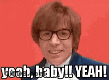 A Man Wearing Glasses And A Suit Is Smiling And Saying `` Yeah , Baby ! Yeah ! '' GIF