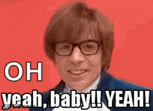 A Man Wearing Glasses And A Suit Is Smiling And Says `` Oh Yeah , Baby ! Yeah ! '' GIF