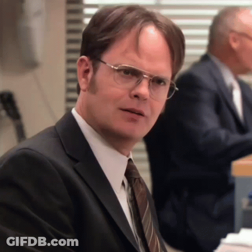 A Man Wearing Glasses And A Suit Looks Serious GIF