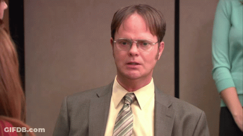A Man Wearing Glasses And A Suit Looks Serious GIF