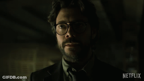 A Man Wearing Glasses And A Suit Says Gracias In Spanish GIF