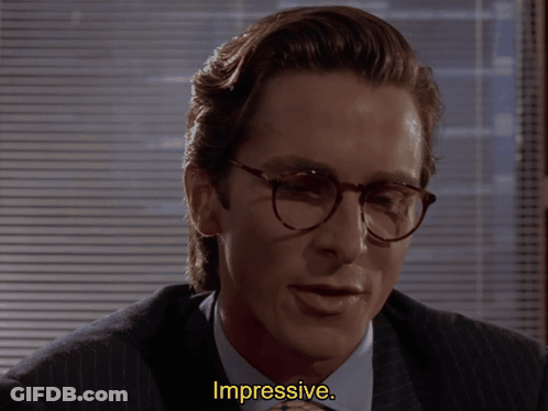 A Man Wearing Glasses And A Suit Says Impressive In Yellow Letters GIF