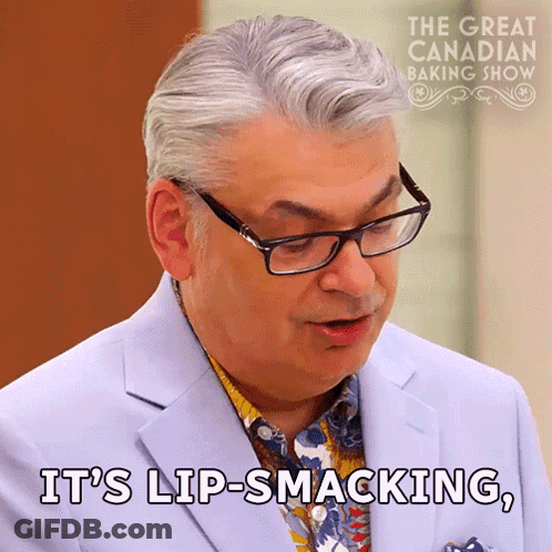 Man In Glasses And Suit Says Lip-Smacking GIF