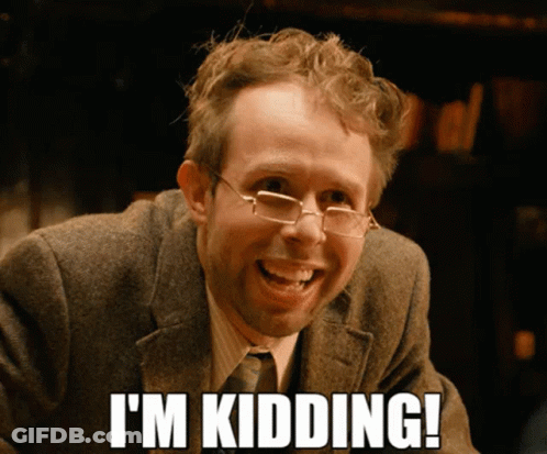 A Man Wearing Glasses And A Suit Smiles And Says " I 'M Kidding " GIF