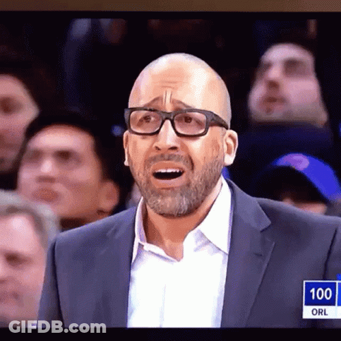 A Man Wearing Glasses And A Suit Stands In Front Of A Crowd With The Number 100 On The Bottom Right GIF