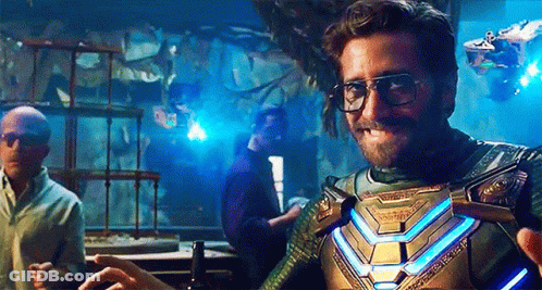 A Man Wearing Glasses And A Superhero Costume Is Standing In A Room With Other Men . GIF
