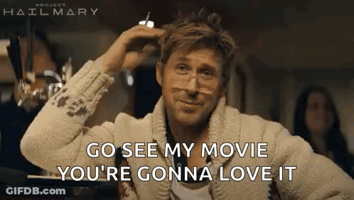 A Man Wearing Glasses And A Sweater Is Sitting At A Table And Talking To Someone . GIF