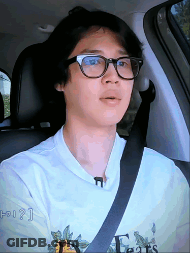 A Man Wearing Glasses And A T-Shirt That Says Fears GIF