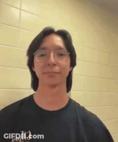 A Man Wearing Glasses And A T-Shirt That Says J.r.g.t. GIF