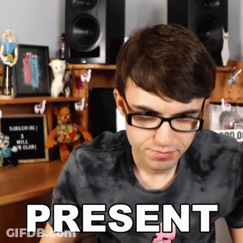 A Man Wearing Glasses And A Tie Dye Shirt Has The Word Present On His Shirt GIF