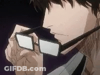 A Man Wearing Glasses And A Tie Is Looking Down At Something . GIF