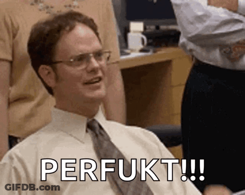 A Man Wearing Glasses And A Tie Is Sitting In A Chair With The Words Perfukt Written On His Face . GIF