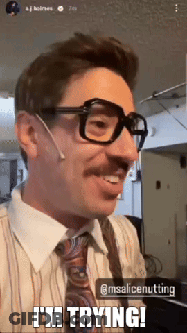 A Man Wearing Glasses And A Tie Is Smiling And Says I 'M Trying GIF