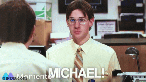 A Man Wearing Glasses And A Tie Is Talking To Another Man With The Words " Michael " On The Bottom Right GIF