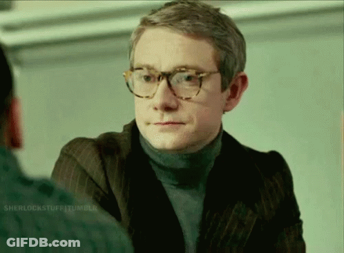 A Man Wearing Glasses And A Turtleneck Sweater GIF
