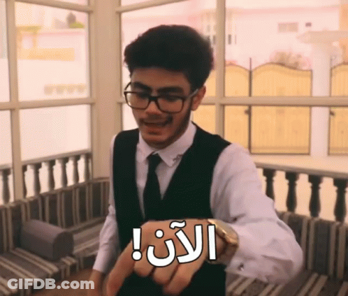 A Man Wearing Glasses And A Vest Has A Watch On His Wrist That Says ' I 'M Late ' GIF