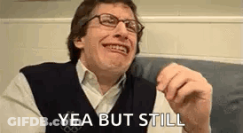 Man In Glasses And Vest Making Funny Face GIF